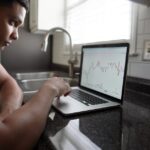 Beginner investor learning about growth stock investing on laptop